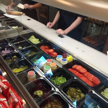 Subway - a woman preparing food in a deli case - Sandwiches Near Me - Coalinga, California