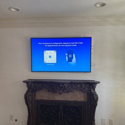 Grindlex Home Services - After: Samsung Frame TV mounted flush above the mantel -- zero visible cables, clean modern look.