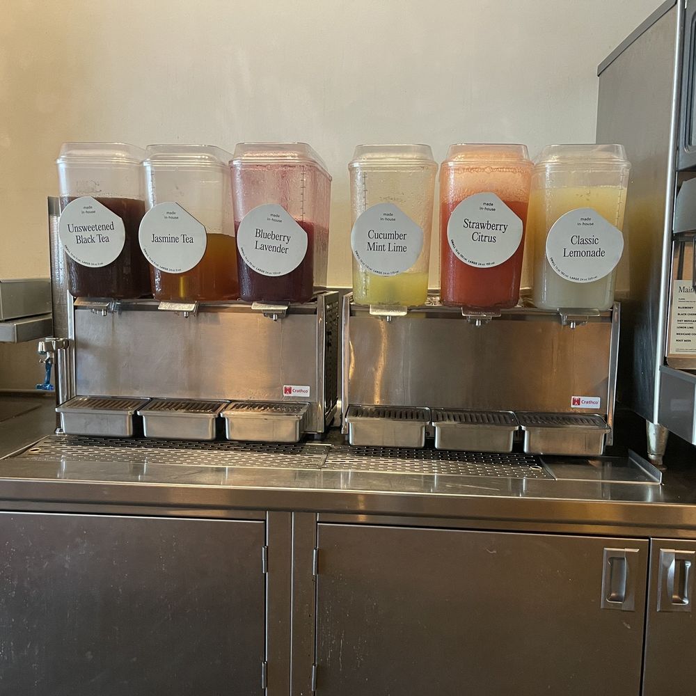 CAVA - a row of juices on a counter - Mediterranean Near Me - Fairfax, Virginia