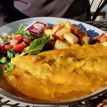 Pistachio's - Chorizo Cheddar Omelet  Chorizo, grilled onions, cheddar cheese omelet, smothered with pork green chile. - Breakfast & Brunch Near Me - Longmont, Colorado