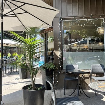 Riverdale Perk Cafe - patio area with tables and umbrellas - Cafes Near Me - Toronto, Ontario