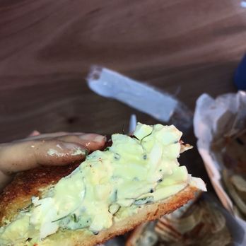 Nu Deli - a person holding a piece of bread - Food Trucks Near Me - Ferndale, Michigan