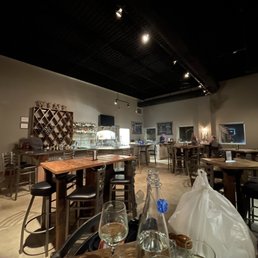 a woman sitting at a table in a restaurant a woman sitting at a table in a restaurant
