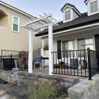 Fence Specialist - White vinyl arbor with black steel fencing - Fences & Gates Near Me Fence Specialist - White vinyl arbor with black steel fencing - Fences & Gates Near Me