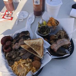 4 meat sampler platter with sides  - smoked sausage, ribs, brisket and pulled pork, mac-n-cheese, collards and sweet potato crunch.