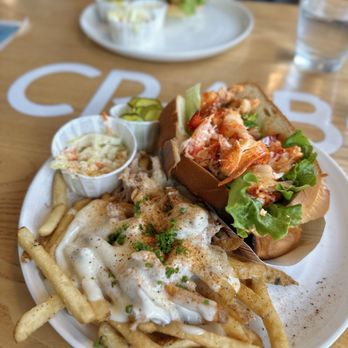 Matt’s Fish Camp - Lobster roll (had it served warm) along with the fish camp fries (topped with crab, bechamel, and old bay). - Seafood Near Me - Fenwick Island, Delaware