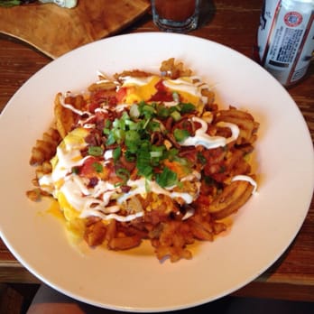 The Half Pint / Ernie's Bar - Colossal Nachos (waffle fries, eggs, salsa, crema, bacon) - American Near Me - New York, New York The Half Pint / Ernie's Bar - Colossal Nachos (waffle fries, eggs, salsa, crema, bacon) - American Near Me - New York, New York