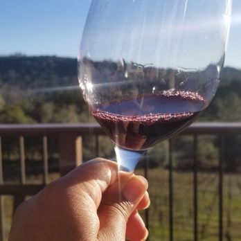 Oakstone Winery - a hand holding a glass of red wine - Wine Tasting Room Near Me - Somerset, California Oakstone Winery - a hand holding a glass of red wine - Wine Tasting Room Near Me - Somerset, California