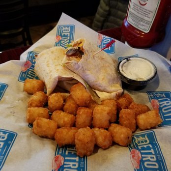 Old Detroit Burger Bar - THE TROY WRAP = grilled chicken, shred lettuce, shred cheddar cheese, bacon, tomatoes in a grilled tortilla, tater tots - Bars Near Me - Troy, Michigan Old Detroit Burger Bar - THE TROY WRAP = grilled chicken, shred lettuce, shred cheddar cheese, bacon, tomatoes in a grilled tortilla, tater tots - Bars Near Me - Troy, Michigan