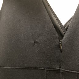 A hole in my Express black dress, that was not there before dropping off.