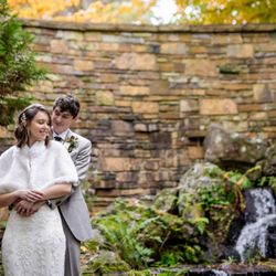 Anthony Chapel - Romantic bride and groom embracing by a waterfall at Anthony Chapel in the lush Hot Springs National Park. Photo: Michele McCoy Photography