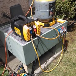 Phillips Heating, Plumbing and Air Conditioning - Recovering refrigerant , keeping the atmosphere safe !