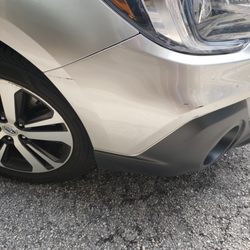 Valet Parking Authority - Damage to front bumper, scrapped against a wall or another vehicle.