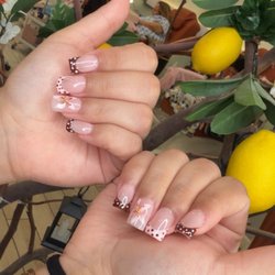 Finesse Nails and Spa - Full set of gel x. Short and square with reverse French tip and polka dots and accent flower