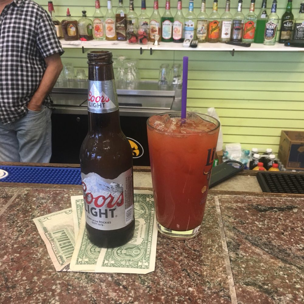 a bottle of booze and a glass of beer a bottle of booze and a glass of beer