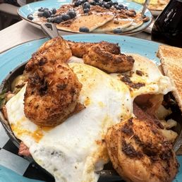Nashville skillet - blackened shrimp, turkey bacon, potatoes, cheddar cheese, and roasted tomatoes with over easy eggs. Highly recommended! Nashville skillet - blackened shrimp, turkey bacon, potatoes, cheddar cheese, and roasted tomatoes with over easy eggs. Highly recommended!