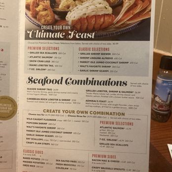 Red Lobster - Red Lobster.  Combinations. - The menu offers seafood combinations including grilled sea scallops, Atlantic salmon, snow crab legs, and lobster tail, with options to create custom meals. It also lists classic and premium seafood selections, sides like baked potato and coleslaw, and additional side options such as bacon mac and cheese and crispy Brussels sprouts. The menu provides calorie information and prices for each item, with choices for sides and customizations. - Seafood Near Me - Albuquerque, New Mexico
