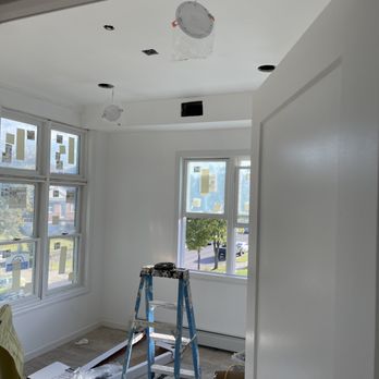 Zee Construction - a ladder in the middle of a room - Electricians Near Me