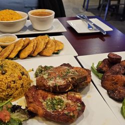 Capicu Latin Cuisine & Sports Bar - Main course. Pork chop, rice, and beans, sweet bananas.