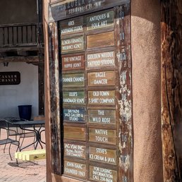 Plazuela Sombra businesses, including Lillie's Handmade Soaps, listed on a sign