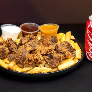 Thang's Fish and Chicken - Seasoned fried gizzards over crinkle fries with sauces and a refreshing Coke. - Seafood Near Me - Houston, Texas Thang's Fish and Chicken - Seasoned fried gizzards over crinkle fries with sauces and a refreshing Coke. - Seafood Near Me - Houston, Texas