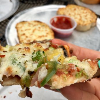 Parkway Pizza - Full of toppings and cheese, with a strong thin crust. - Pizza Near Me - Minneapolis, Minnesota
