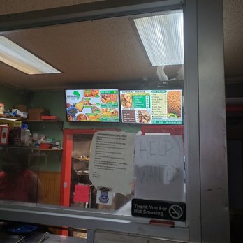 Africana Restaurant - a menu and a sign in the window - African Near Me - Jamaica, New York Africana Restaurant - a menu and a sign in the window - African Near Me - Jamaica, New York