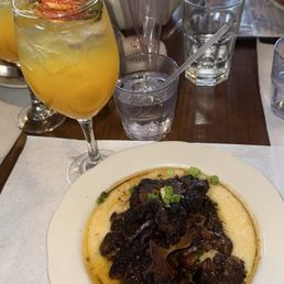 Braised oxtails and grits Braised oxtails and grits