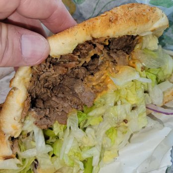 Subway - a hand holding a sandwich with meat and lettuce - Sandwiches Near Me - Chandler, Arizona Subway - a hand holding a sandwich with meat and lettuce - Sandwiches Near Me - Chandler, Arizona