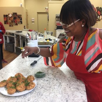 Kitchen Social - Abra sprinkling parsley - Cooking Classes Near Me - Fort Myers, Florida
