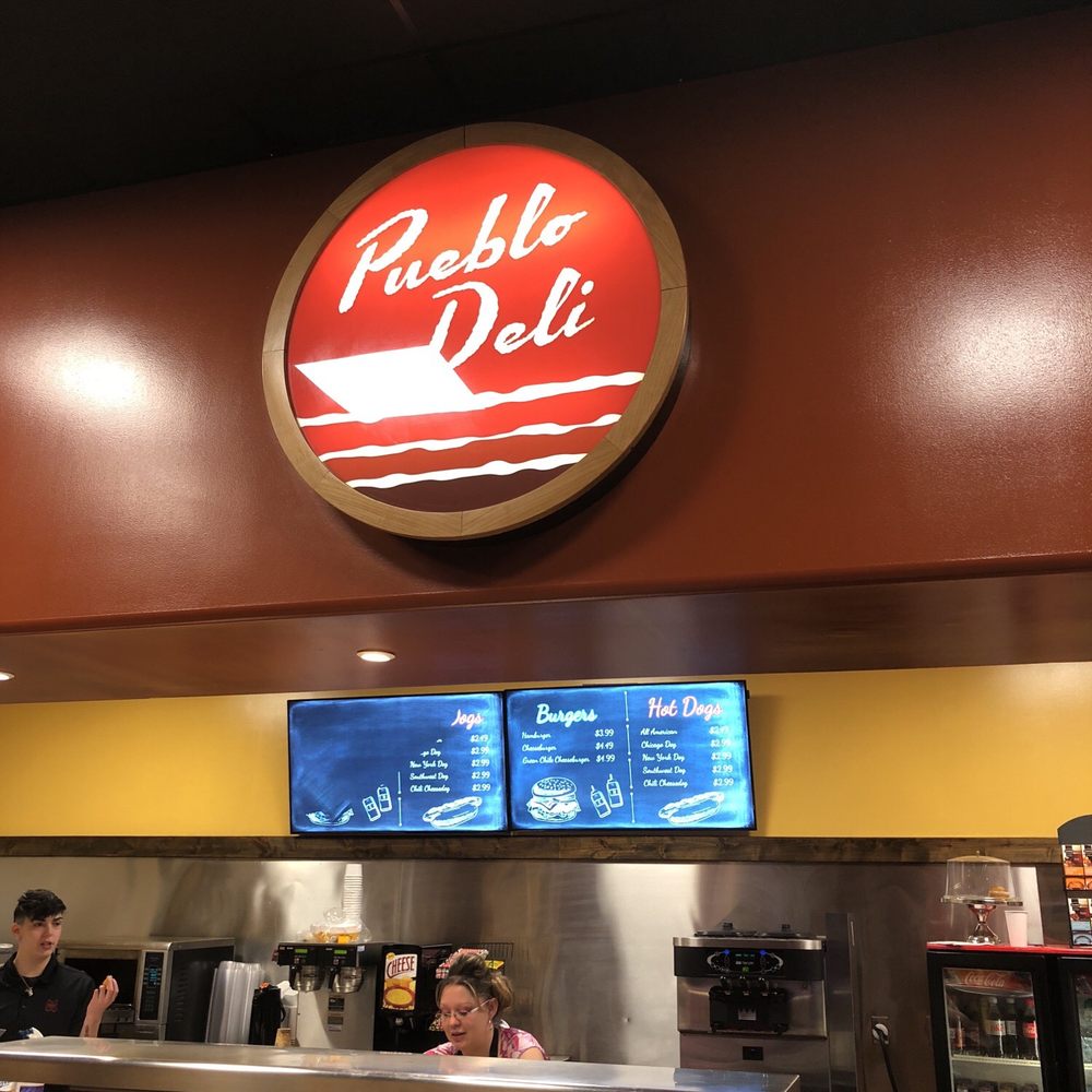 Pueblo Deli - a restaurant counter with a sign above the counter - Cafes Near Me - Santa Fe, New Mexico