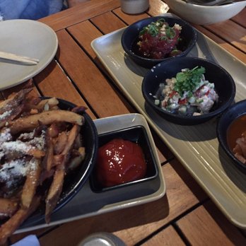 Monkeypod Kitchen - Trio of pokes- poisson cru or Tahitian poke, traditional Hawaiian poke as well as tako poke. And the garlic truffle oil French fries - Hawaiian Near Me - Kapolei, Hawaii