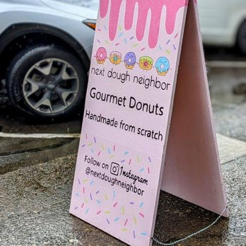 Next Dough Neighbor - a pink sign with donuts on it - Donuts Near Me - Camas, Washington