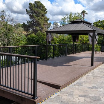 Second Wind Deck Master - A wheelchair ramp was a better option than following the contour of the wavy pool deck - Decks & Railing Near Me