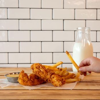 Hardee's - a person holding a glass of milk and fries - Burgers Near Me - Benton, Kentucky