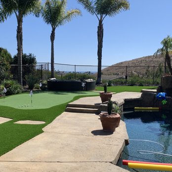 Stoneface - a backyard with artificial grass and a pool - Masonry/Concrete Near Me - San Juan Capistrano, California
