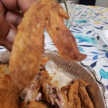 Full Moon Diner - a hand picking up a piece of fried chicken - American Near Me - Lake Bluff, Illinois