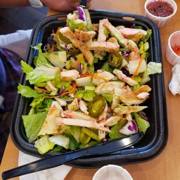 a person eating a salad at a restaurant a person eating a salad at a restaurant