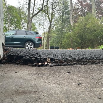 Iron Eagle Asphalt & Paving - his is view from my garage showing the surface was not flush but two inches higher leading to water coming into the garag. - Excavation Services Near Me - Youngstown, Ohio