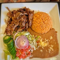 Frida's Cantina & Grill - Carnitas with Mexican rice and beans.