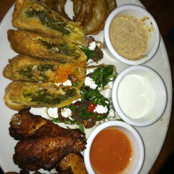 The Pit - Sampler. Wings, onion rings, bacon bruschetta w/goat cheese/caramelized onion, amazing BBQ soul rolls w/collards & pulled pork. - Barbeque Near Me - Raleigh, North Carolina The Pit - Sampler. Wings, onion rings, bacon bruschetta w/goat cheese/caramelized onion, amazing BBQ soul rolls w/collards & pulled pork. - Barbeque Near Me - Raleigh, North Carolina