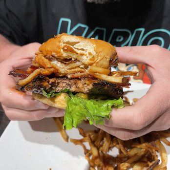 Local Goat - TN Whiskey Glazed Burger* after a bite - New American Near Me - Pigeon Forge, Tennessee