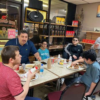 Mustafa's Place - mustafa serving and charting with the guests - Pizza Near Me - Harrisburg, North Carolina Mustafa's Place - mustafa serving and charting with the guests - Pizza Near Me - Harrisburg, North Carolina
