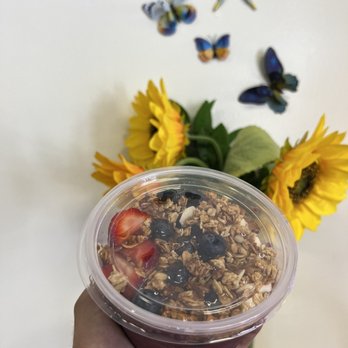 Smakk'D Refreshers & Teas - a hand holding a cup of tea and a vase of sunflowers - Coffee & Tea Near Me - Lakewood, California Smakk'D Refreshers & Teas - a hand holding a cup of tea and a vase of sunflowers - Coffee & Tea Near Me - Lakewood, California
