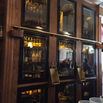Caves Corvallis - Their bottle selection with rail for ladder. - Beer Bar Near Me - Corvallis, Oregon