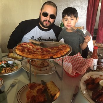 Photo of Four Corners Pizza & Pasta - El Sobrante, CA, United States. Freshly Baked Garlic Bread Chicken Wings Small Caesar Salad Baked Ravioli Stuffed with Cheese a la Carte Custom Pizza