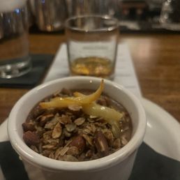 Chocolate pot de crème and amaro in the background Chocolate pot de crème and amaro in the background