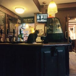 White Horse - Socks (the pub cat) perched on the bar.