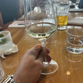 Earls Kitchen + Bar - A glass of Settlement Sauvignon Blanc. Stephanie helped me taste a couple of options before I picked this one. - New American Near Me - Miami, Florida
