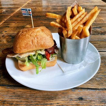 The Marq - a burger and french fries on a plate - New American Near Me - Chicago, Illinois The Marq - a burger and french fries on a plate - New American Near Me - Chicago, Illinois